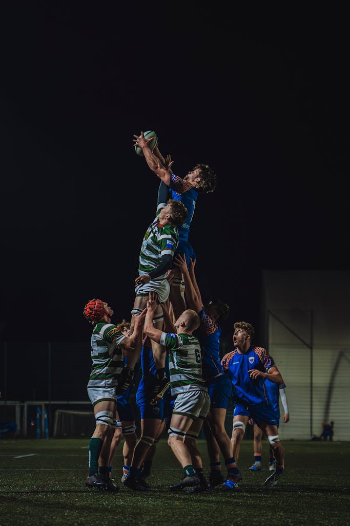 Exciting night-time rugby match showcasing a line-out in England.